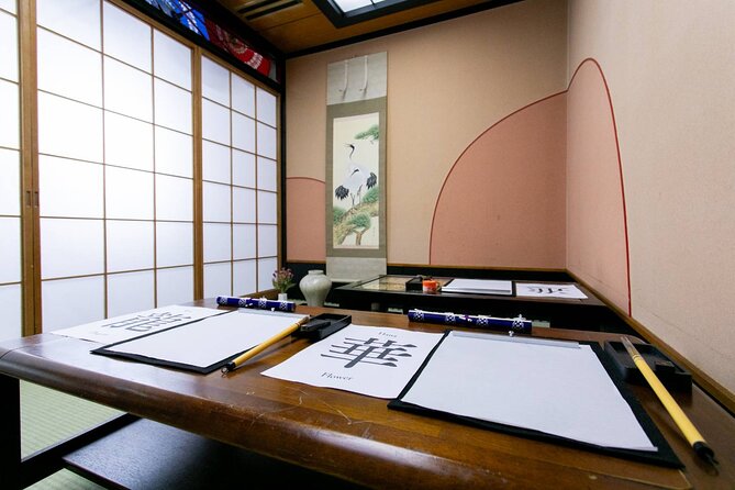 Learning Zen of Japanese Calligraphy in kimono near Osaka Castle - Practice sheets lead to a final work of art
