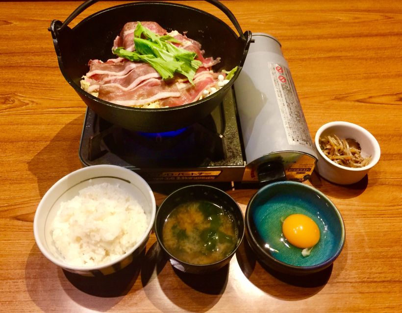 Osaka: Food Tour at Night with Tastings - Wooden storefronts, neon signs, and side streets